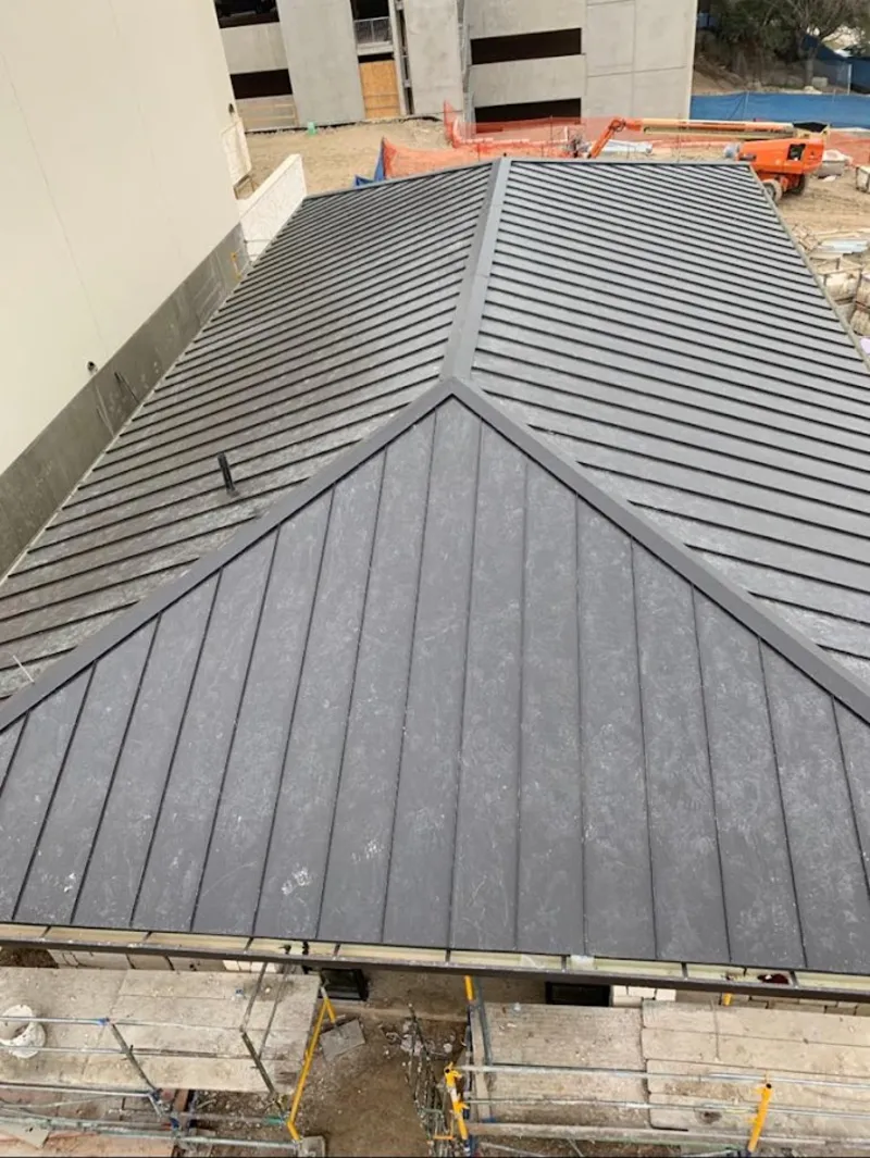 Commercial metal roof construction with crane equipment in Niagara