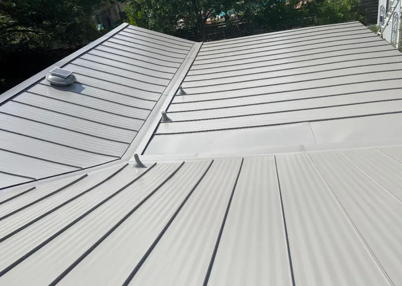 Solar attic fan installed on a metal roof for Roof Ventilation in Niagara